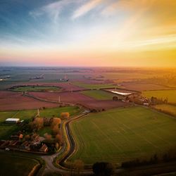 Aerial view of agricultural field against sky during sunset