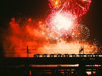 Low angle view of firework display against sky at night