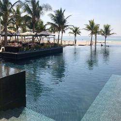 Swimming pool by sea against sky