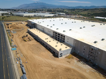 High angle view of cars on land against sky