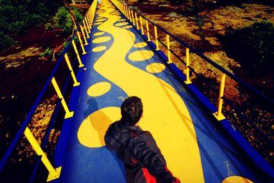 High angle view of man standing on railing