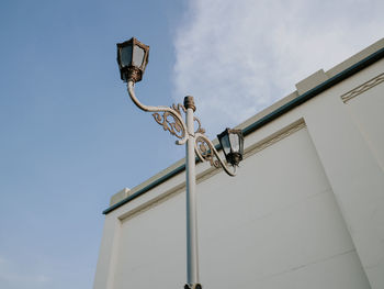 Low angle view of street light against building