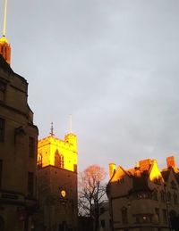 Low angle view of buildings against sky at sunset