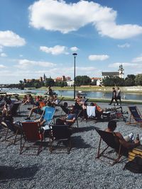 Group of people relaxing by the lake