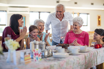 Grandparents celebrating a birthday with their granddaughter