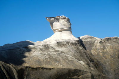 Low angle view of statue against clear blue sky