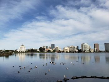 View of lake and buildings against sky