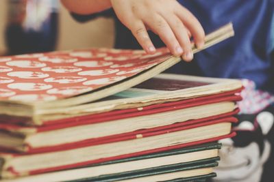 Midsection of person opening book