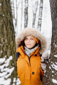 Portrait of woman in snow at forest