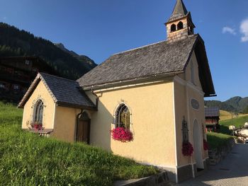 Houses by building against sky