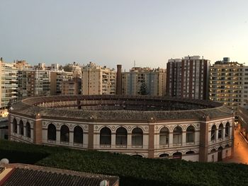 Buildings in city against clear sky