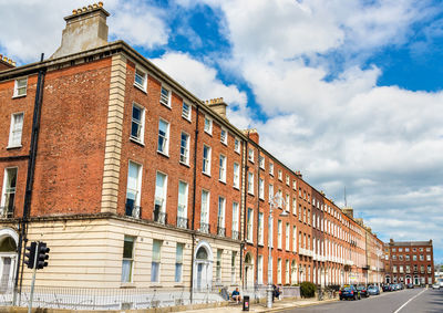 Low angle view of buildings in town against sky