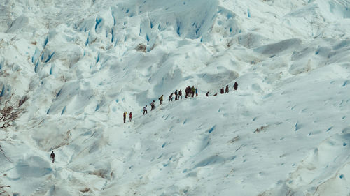 Low angle view of people in snowcapped mountains