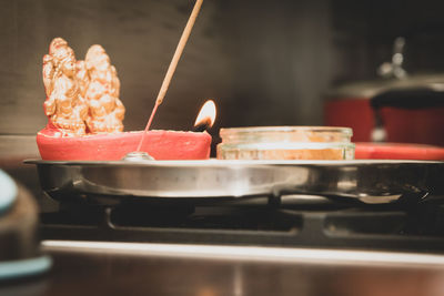 Close-up of illuminated candles in temple