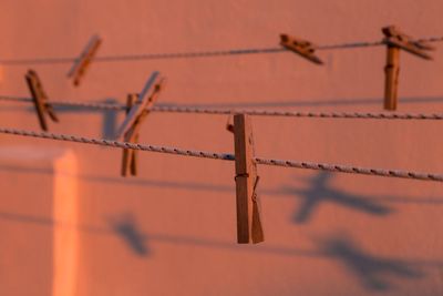 Close-up of barbed wire fence against wall