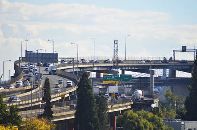 High angle view of factory and highway against sky