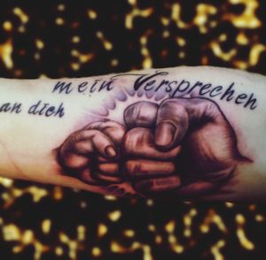 Close-up of hand with text on bed