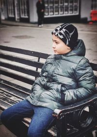 Boy looking away while sitting in bus