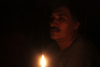 Portrait of man looking away at night