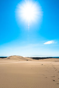 Scenic view of desert against blue sky