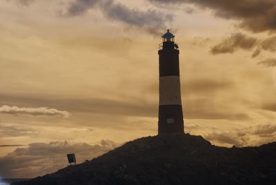 Low angle view of lighthouse against sky during sunset