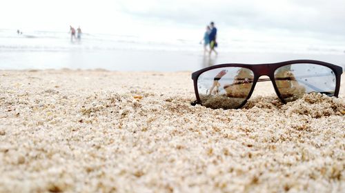 Close-up of sunglasses at beach