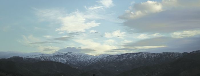 Scenic view of mountains against cloudy sky