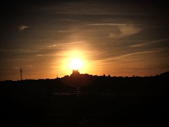 Silhouette landscape against sky during sunset