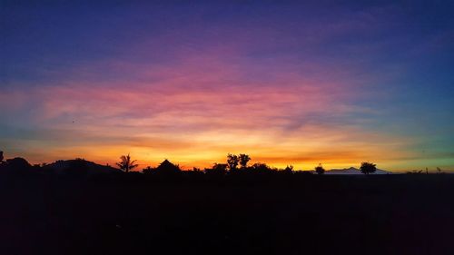 Scenic view of silhouette landscape against sky at sunset