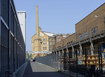 Buildings in city against clear blue sky