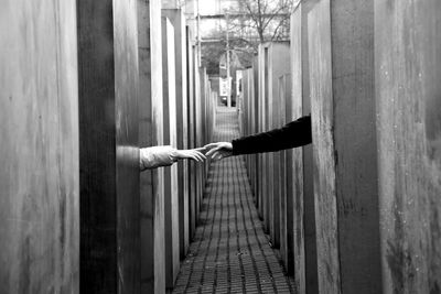 Hands of couple touching in alley