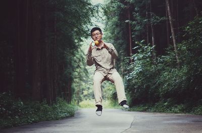 Portrait of man jumping in air playing with ball