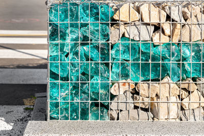 Close-up of metal fence against wall