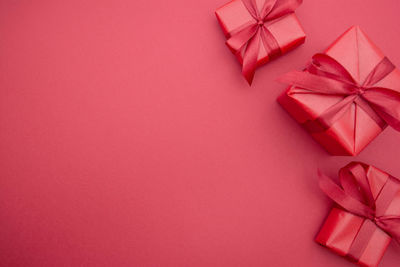 High angle view of christmas decorations on pink background