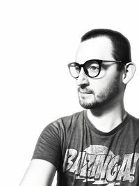 Portrait of young man wearing eyeglasses against white background