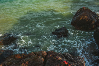 High angle view of rocks in sea