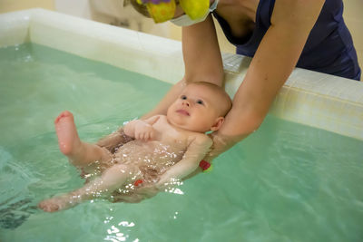 High angle view of people enjoying in swimming pool