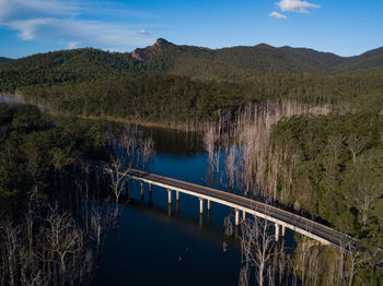 Scenic view of lake and mountains against blue sky