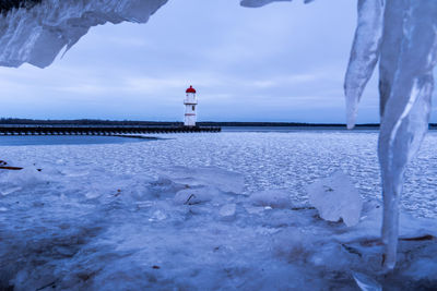 Lighthouse against sky during winter