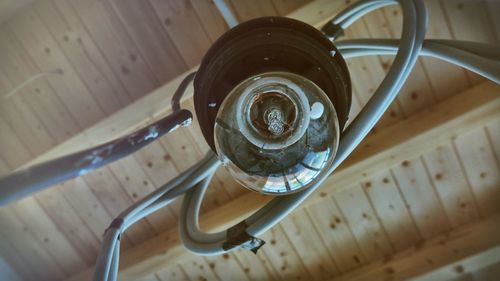 Directly below shot of light bulb hanging by ceiling