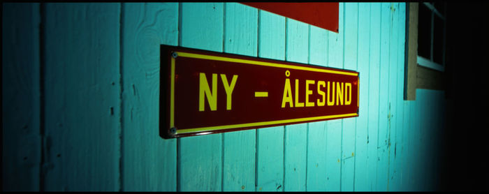 Close-up of information sign on wall