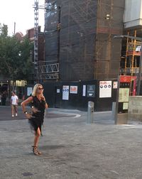 Full length of woman standing in city