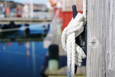 Close-up of rope tied on wooden post