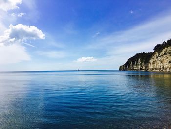 Scenic view of sea against blue sky