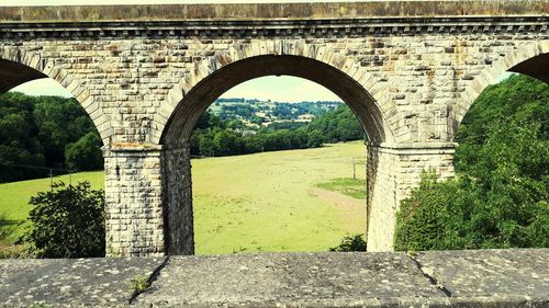 Arch bridge against trees