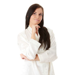 Portrait of a smiling young woman against white background