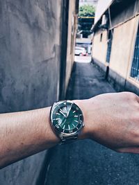 Close-up of hand holding clock