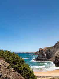 Scenic view of sea against clear blue sky