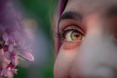 Close-up of woman with pink flower