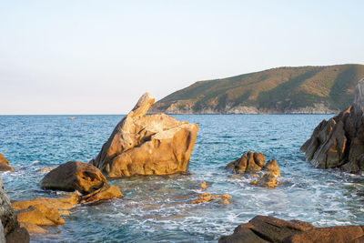 Nearshore rocks standing from the sea